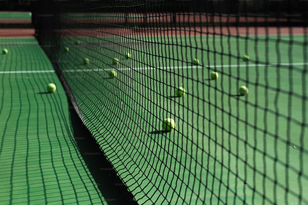 a tennis court with several tennis balls on it