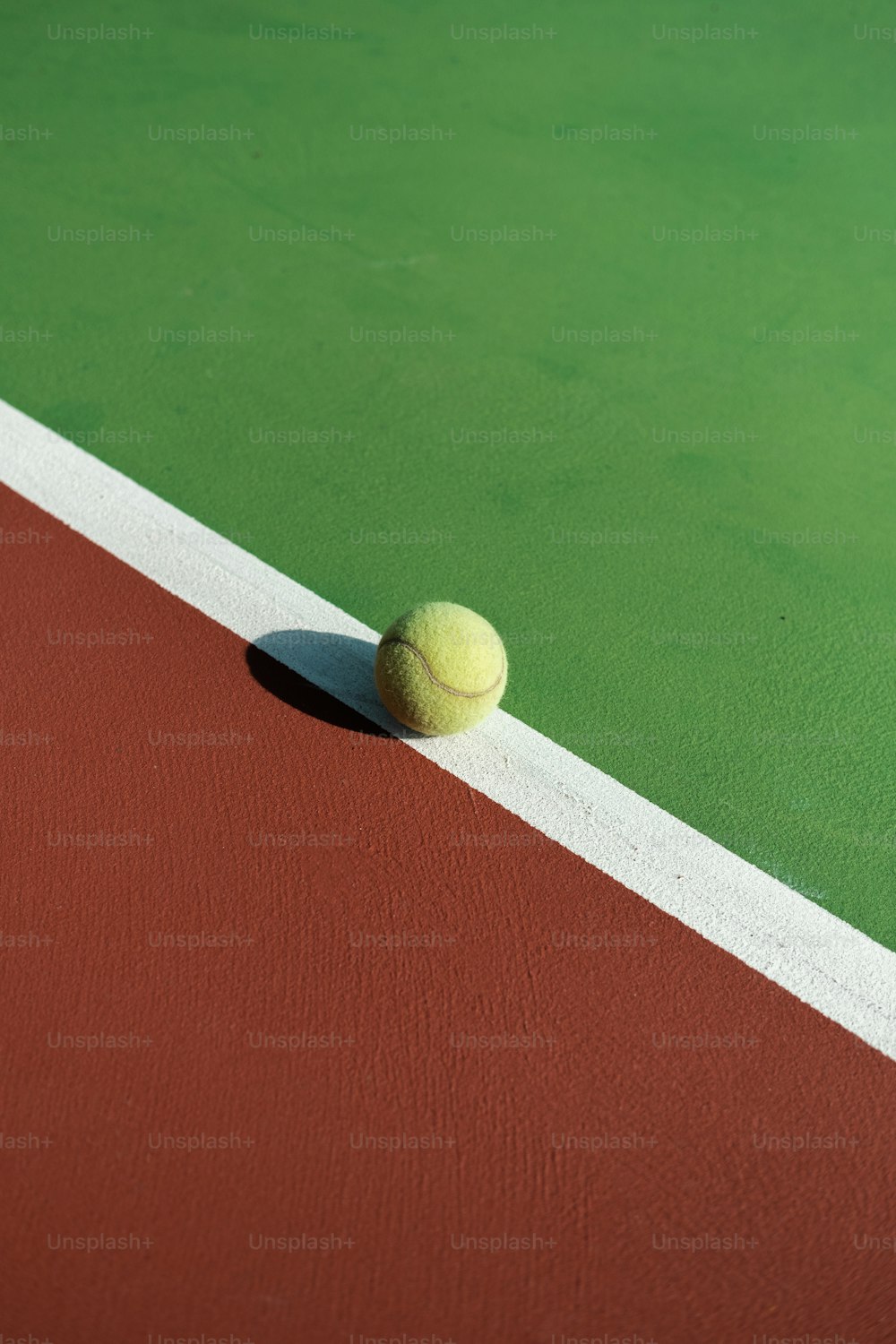 a tennis ball sitting on a tennis court