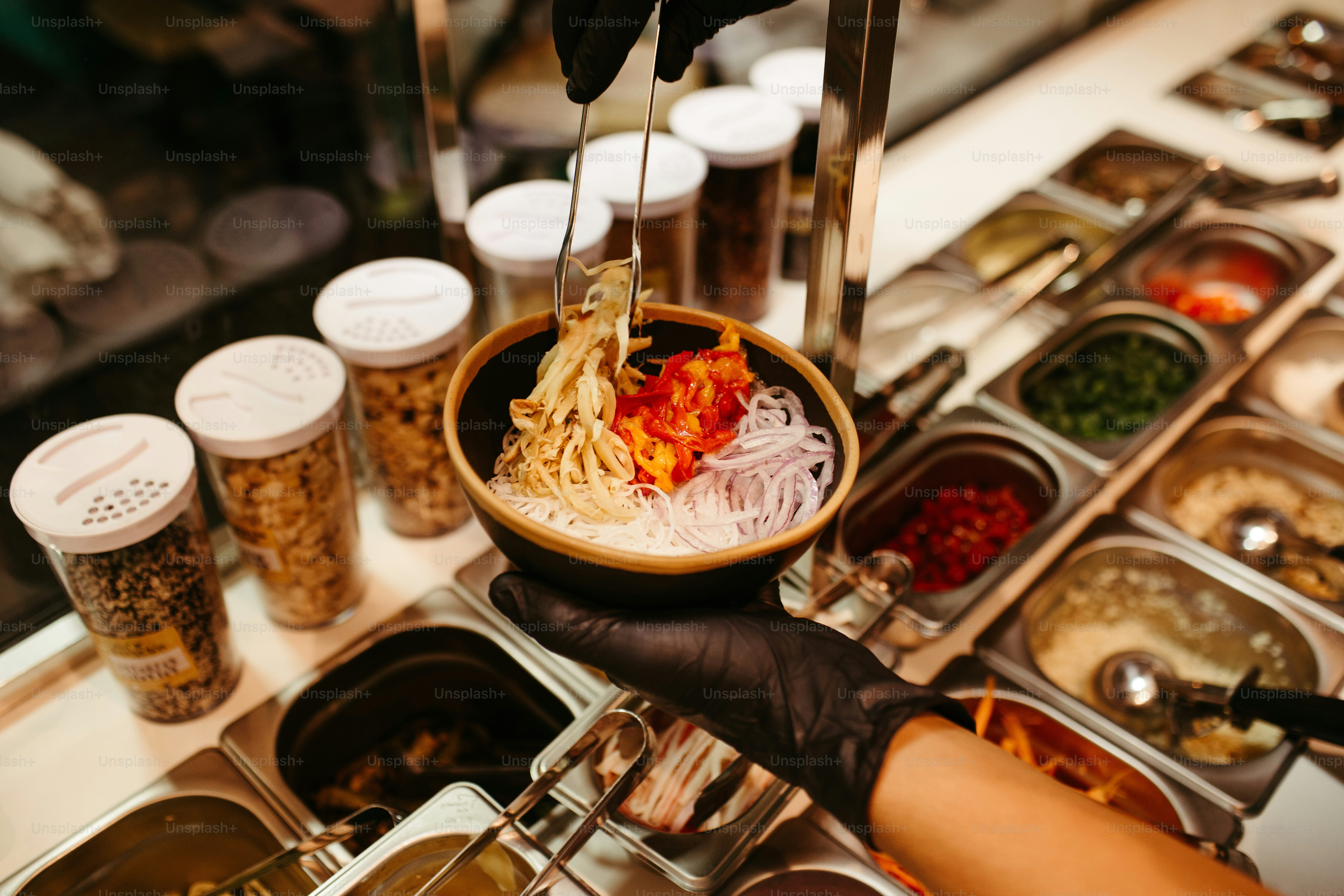 a person holding a bowl of food in their hand