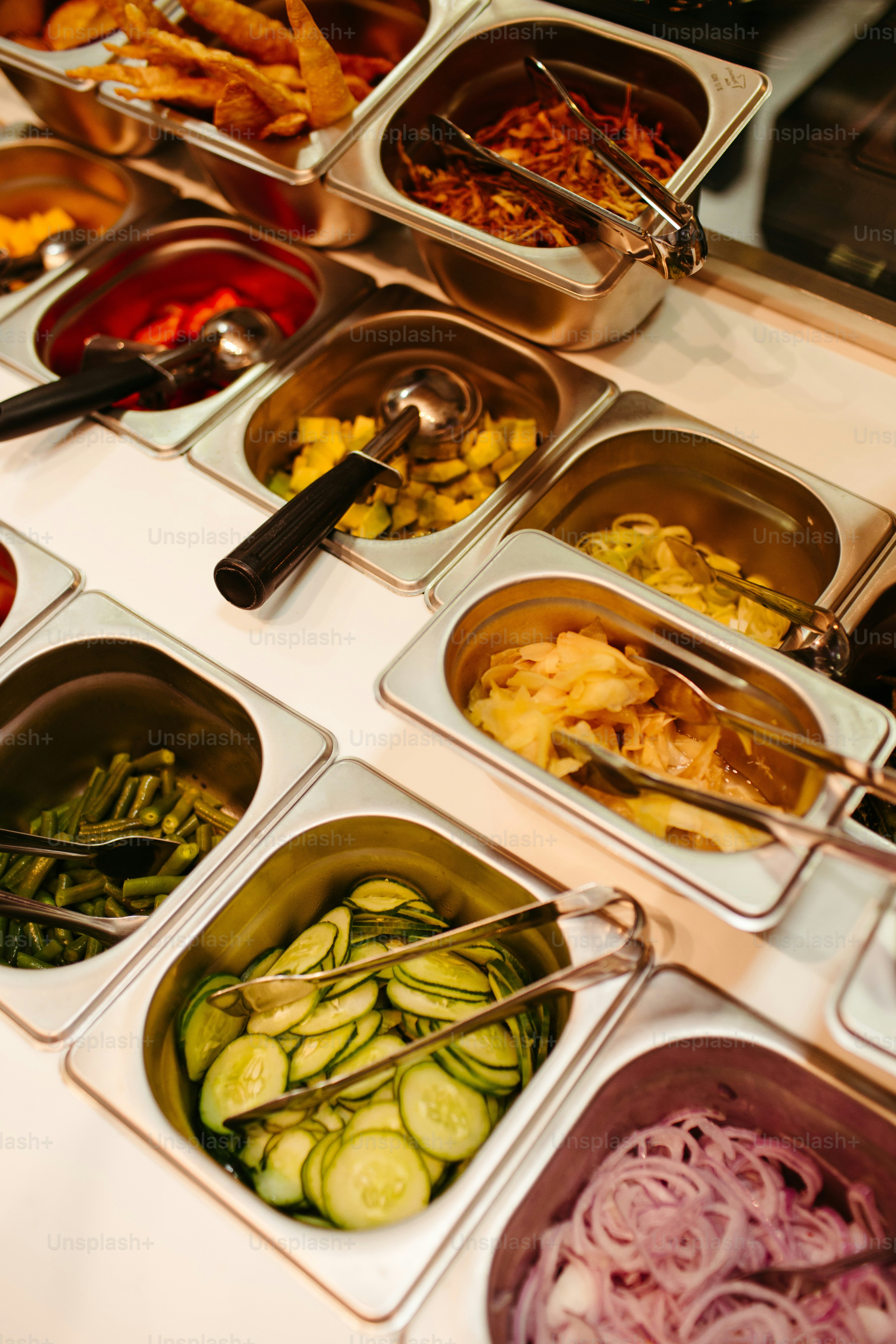 a table topped with lots of trays of food