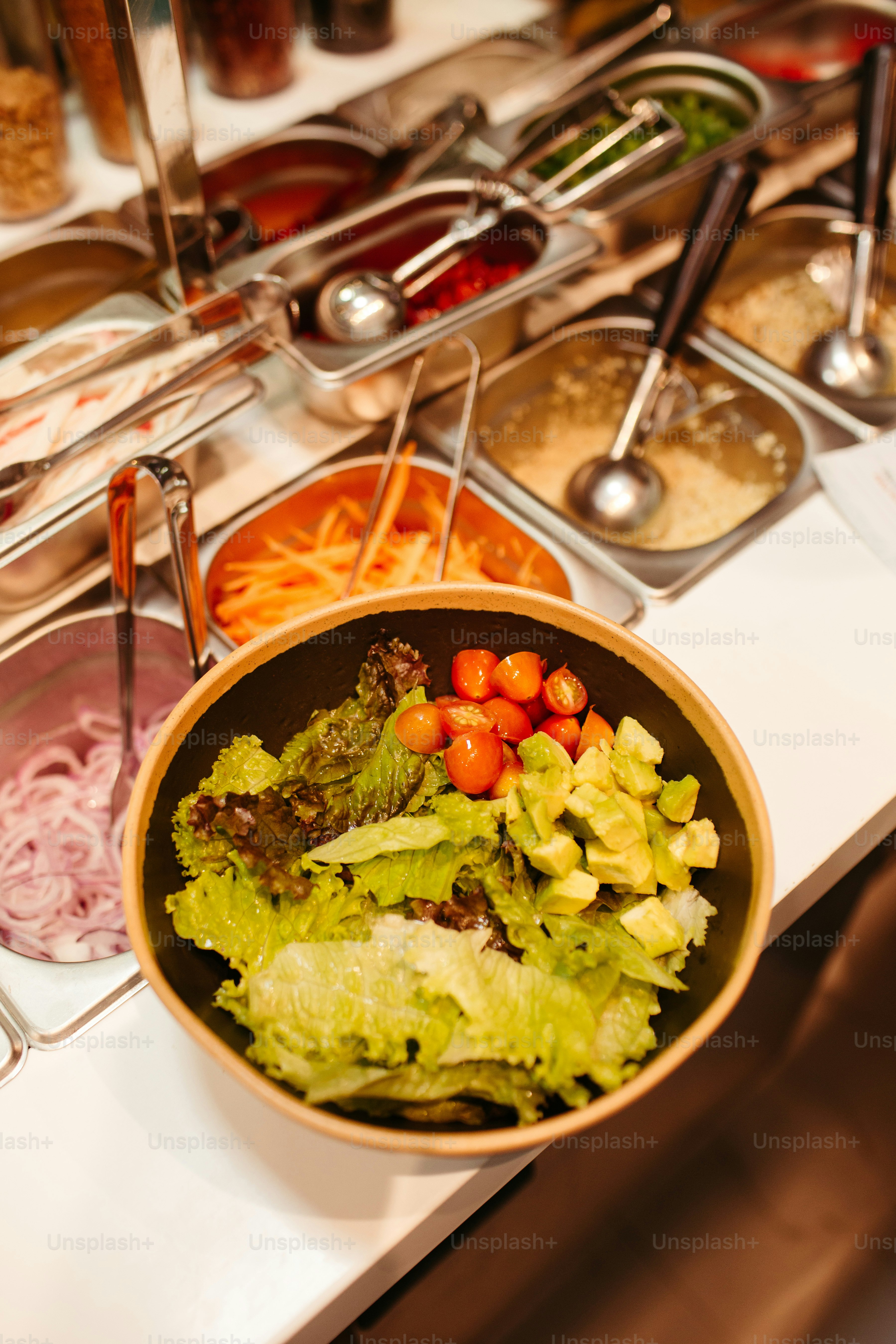 a bowl of salad sits on a table
