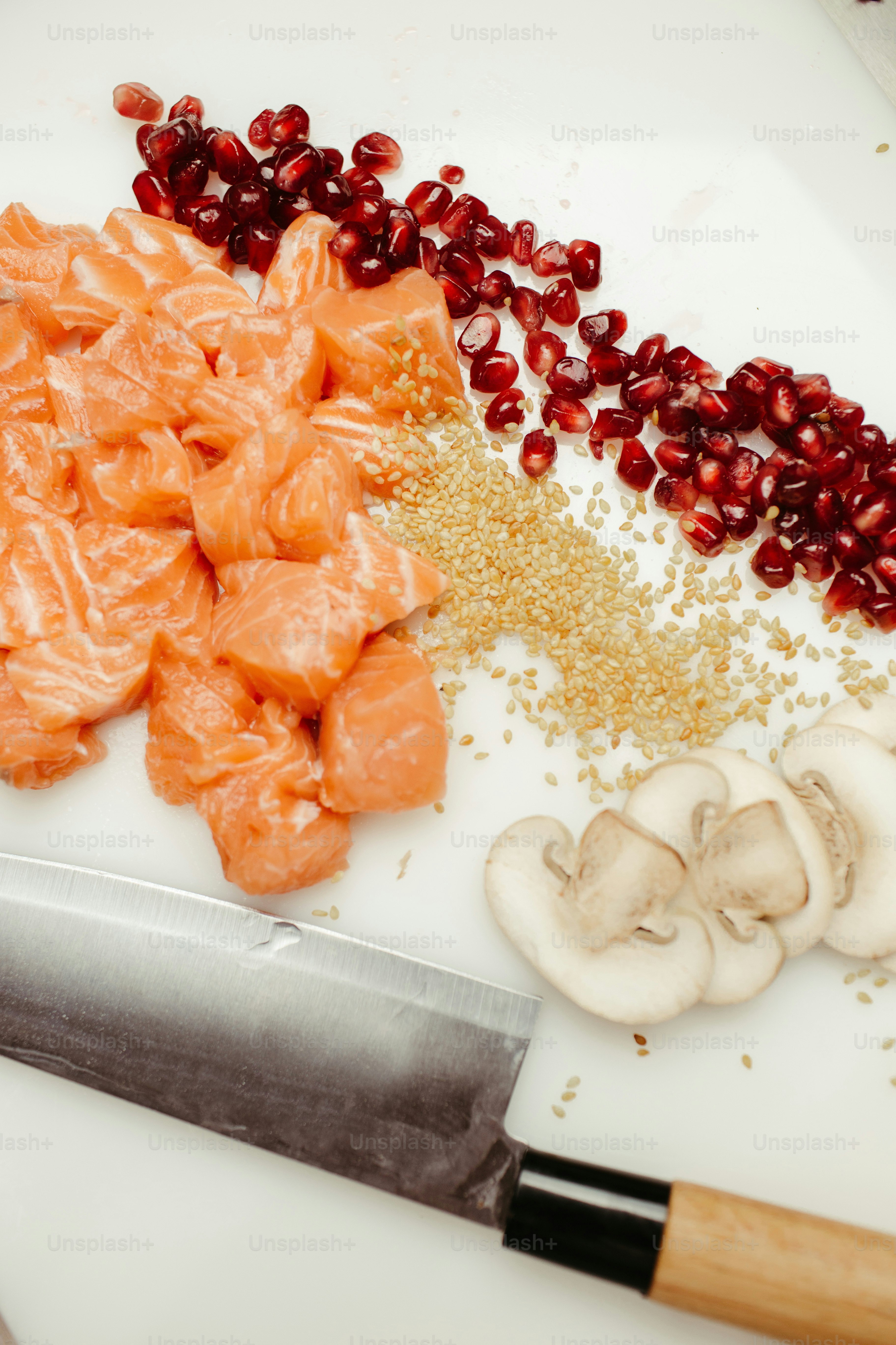 a white cutting board topped with sliced salmon and mushrooms