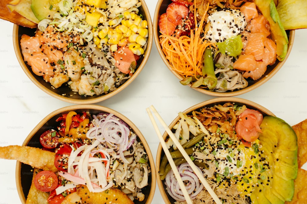 four bowls filled with different types of food