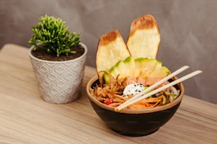 a wooden table topped with a bowl of food