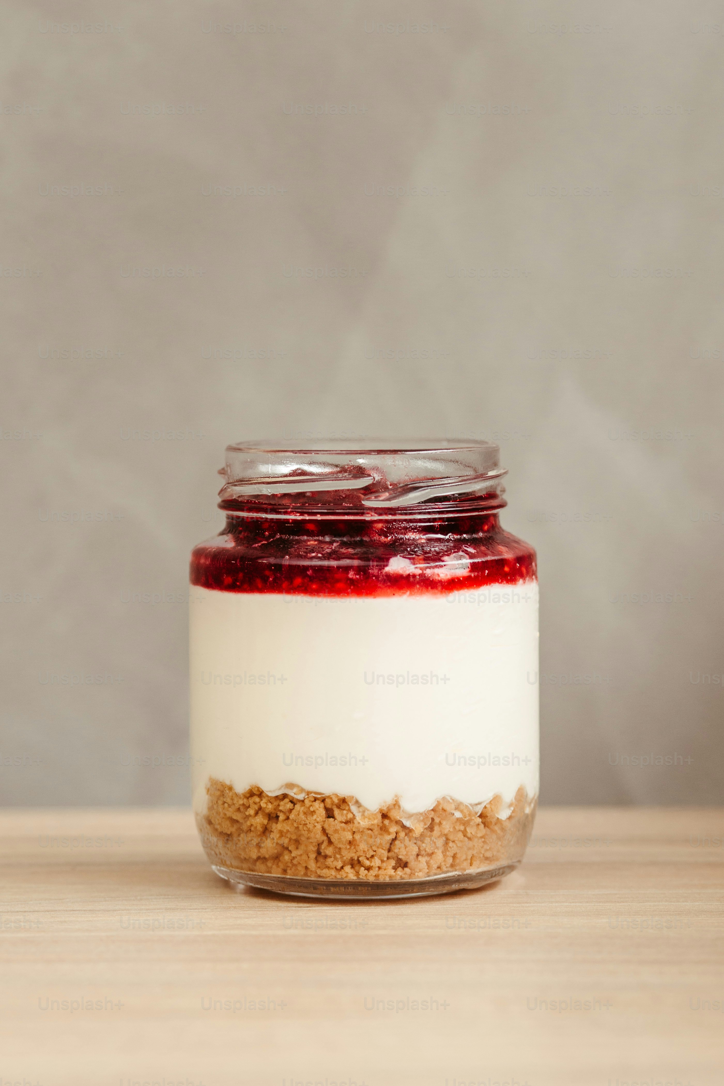 A jar of food sitting on top of a wooden table photo – Yogurt Image on ...