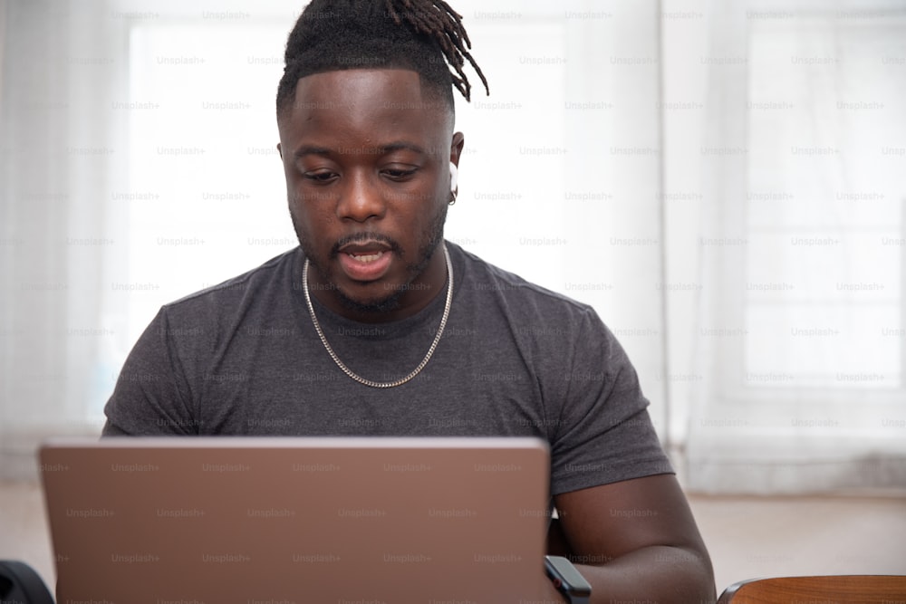 a man sitting in front of a laptop computer