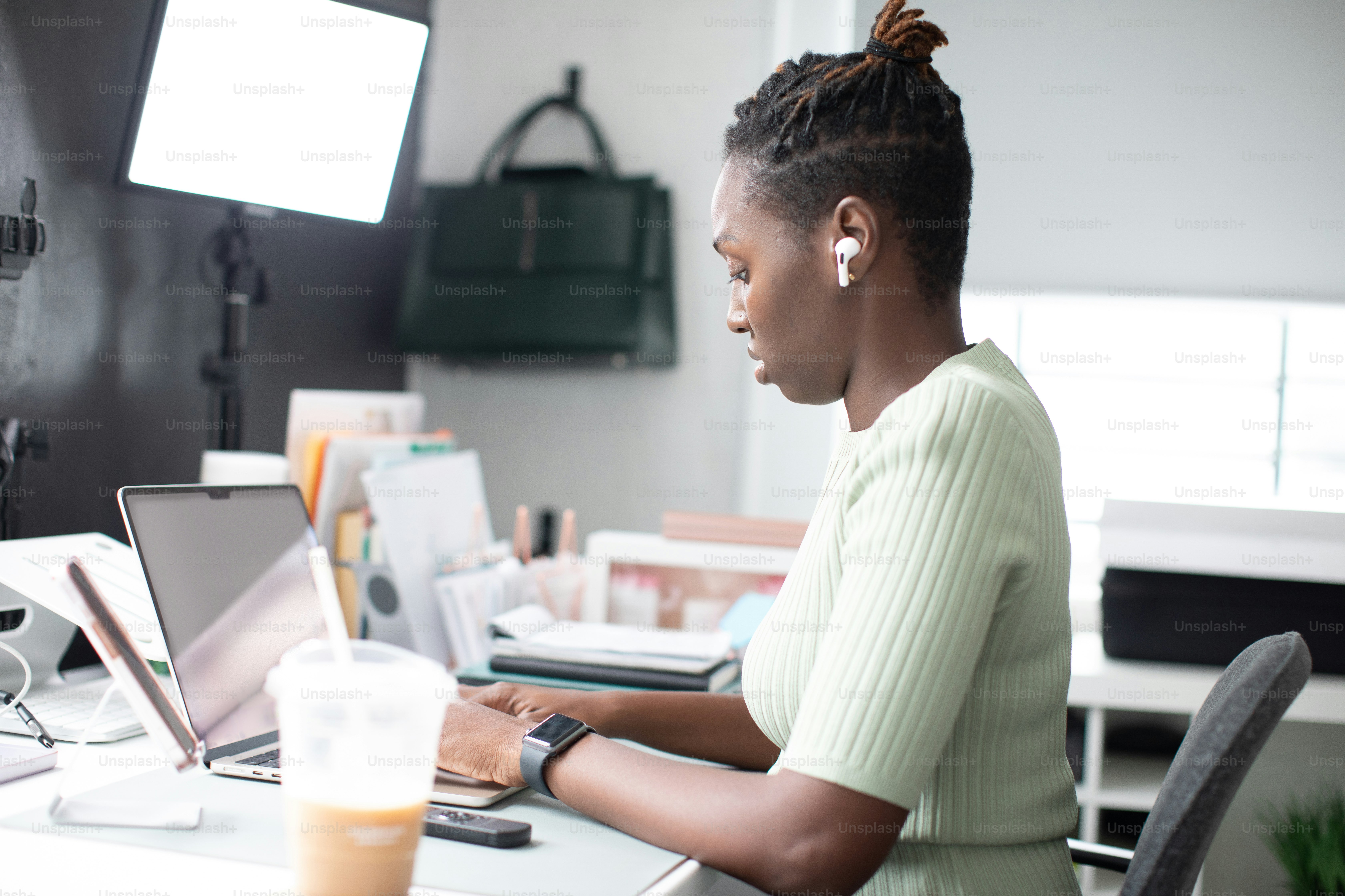 a woman sitting at a desk using a laptop computer