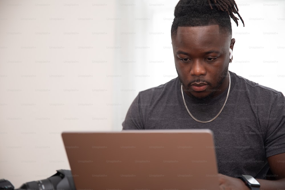 a man sitting in front of a laptop computer