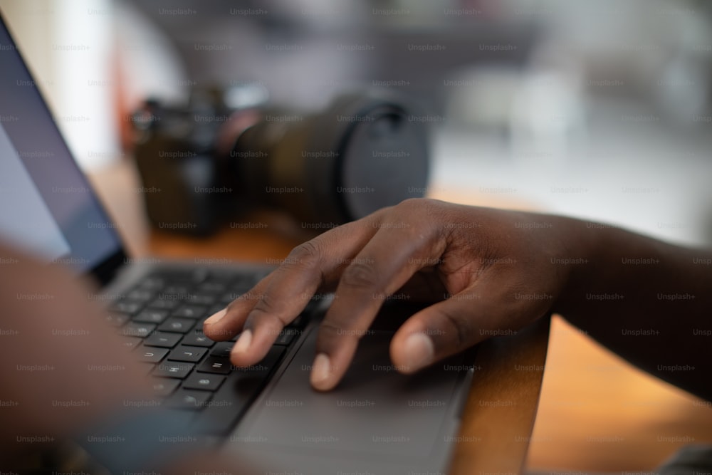 a close up of a person typing on a laptop