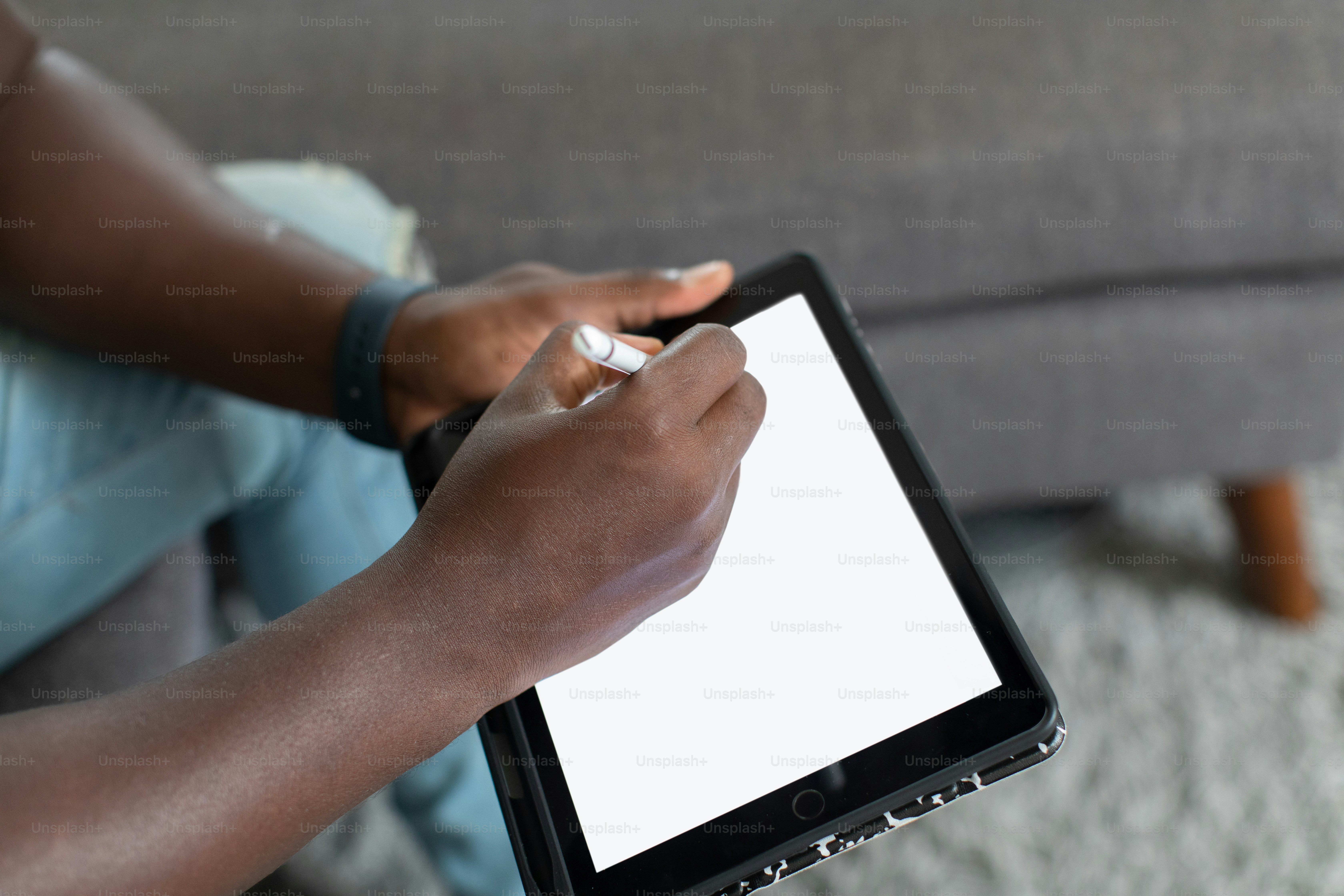 a woman is holding a tablet with a white screen