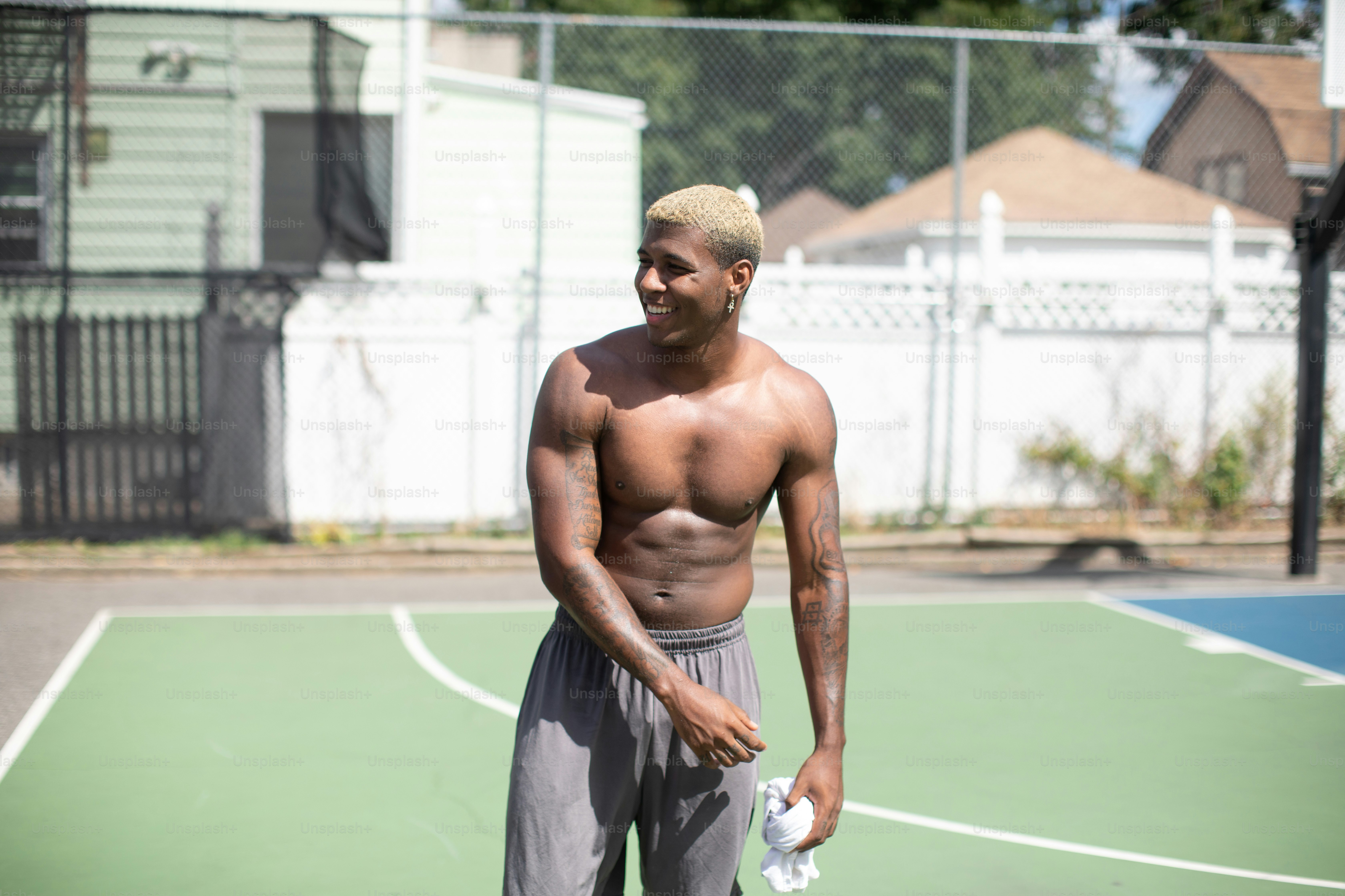 a man standing on a tennis court holding a tennis racquet