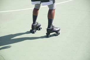 a person riding a skateboard on a tennis court