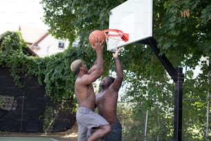 two men playing basketball on a basketball court