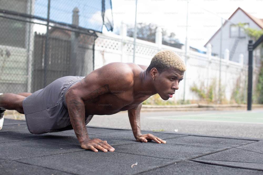 a man is doing push ups on the ground