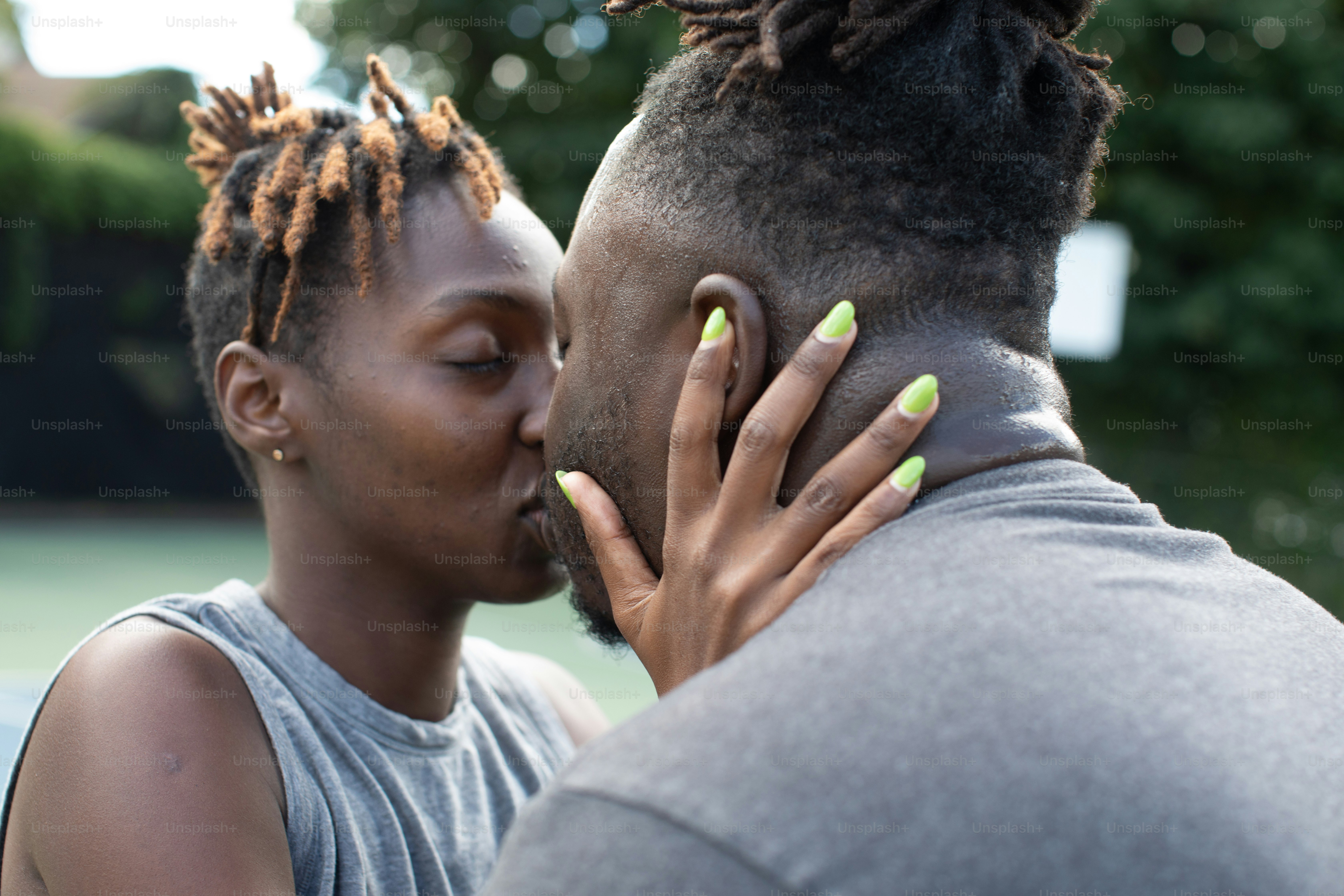 a man kissing a woman on the cheek