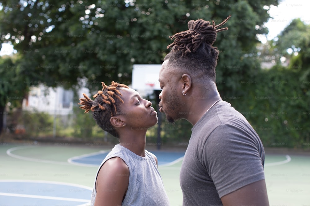 a man and a woman standing next to each other on a tennis court