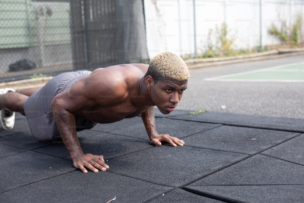 a man is doing push ups on the ground