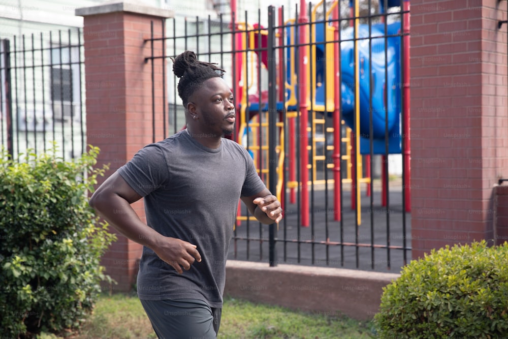 a woman running in front of a playground