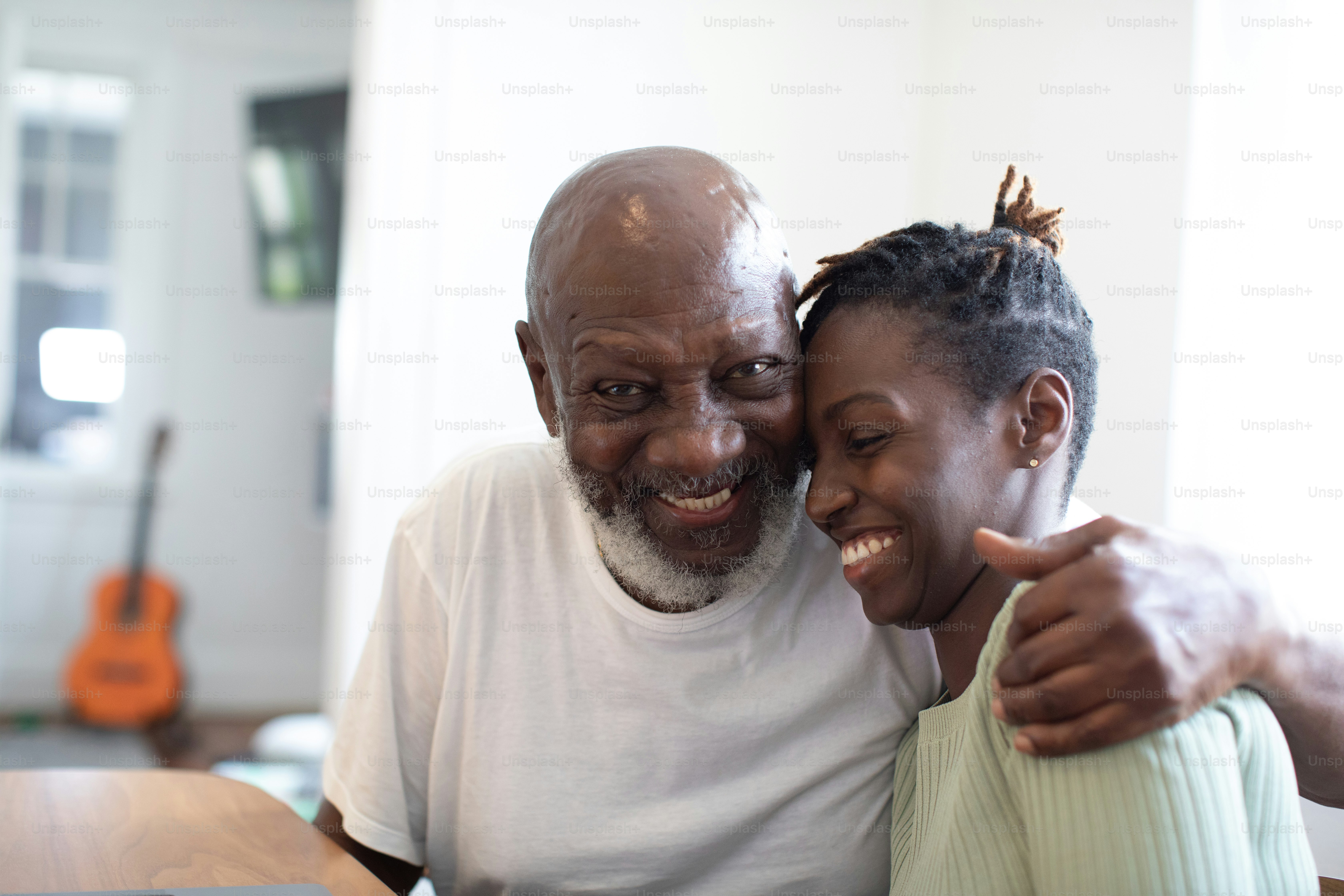 a man and a woman smile as they pose for a picture