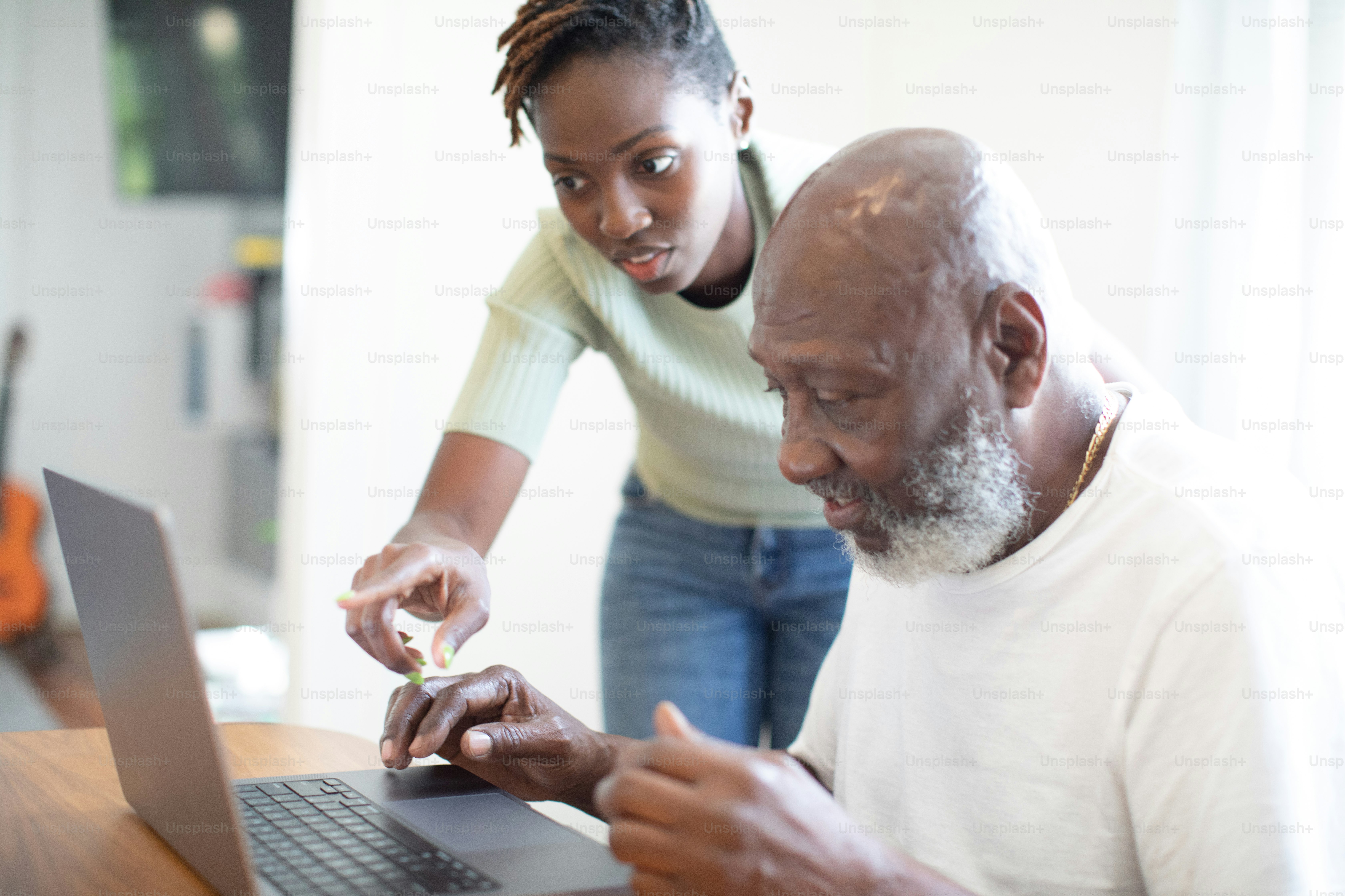 a man and a woman looking at a laptop