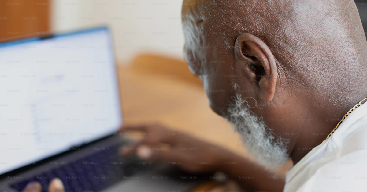 Unsplash Main Using Computer A man with a beard using a laptop computer photo – Laptop Image on Unsplash