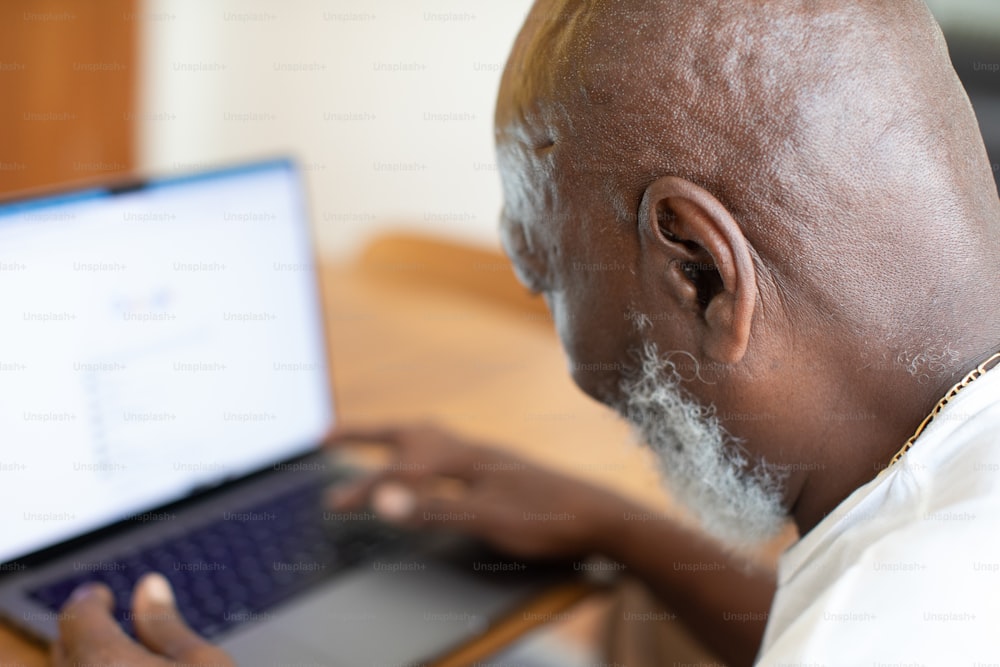 a man with a beard using a laptop computer