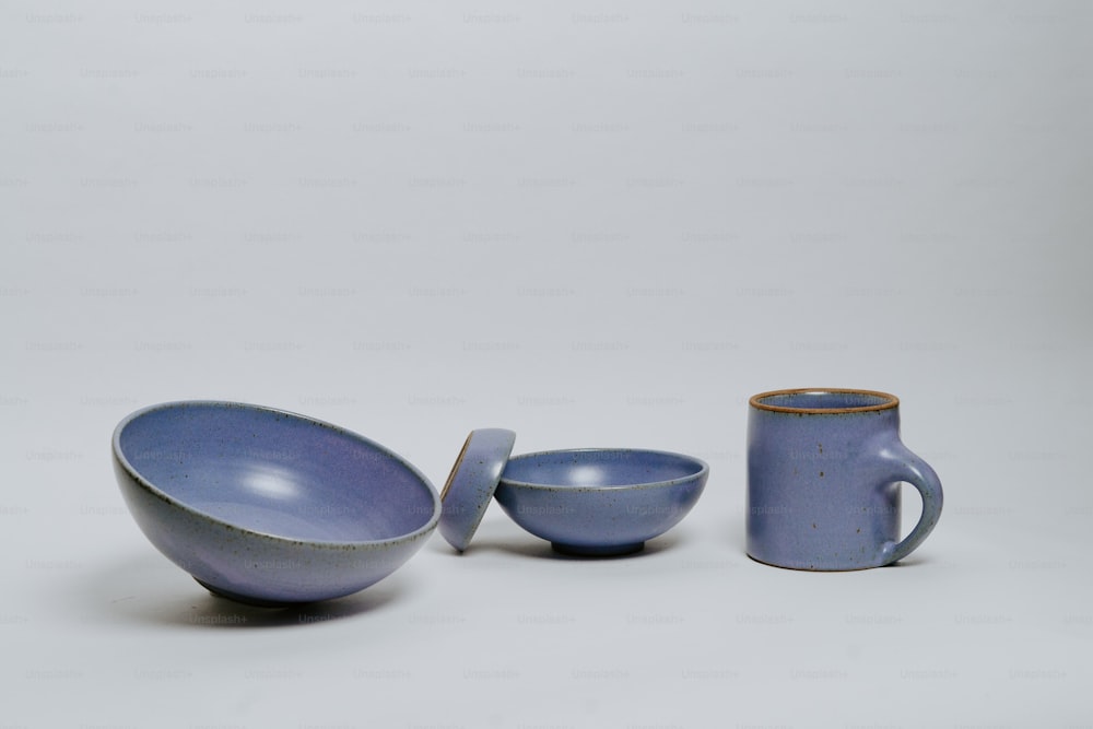 a couple of bowls and a cup sitting next to each other