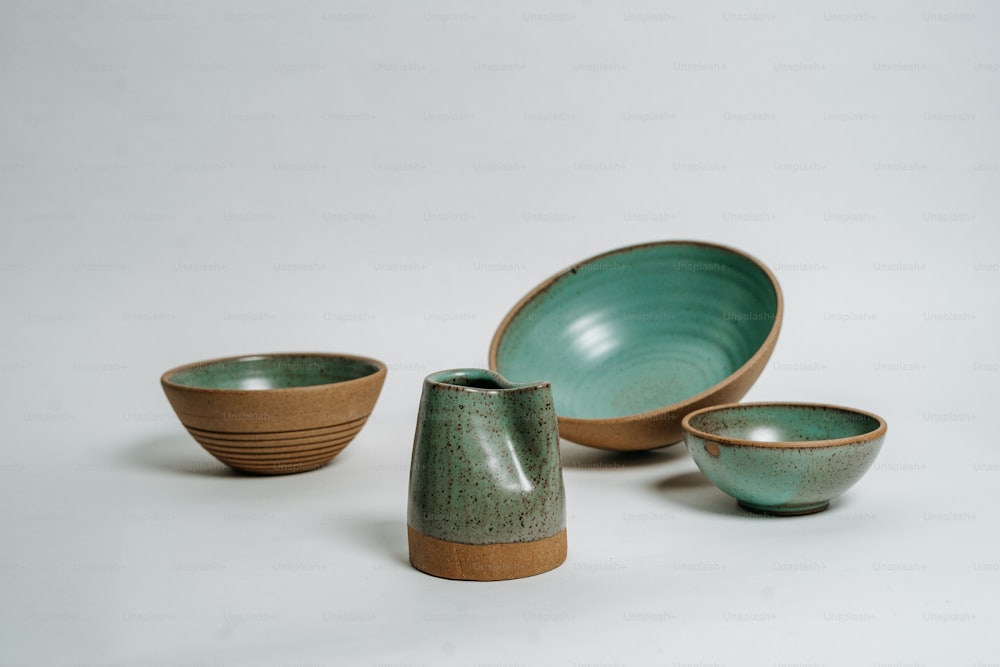 a group of bowls and cups on a white surface