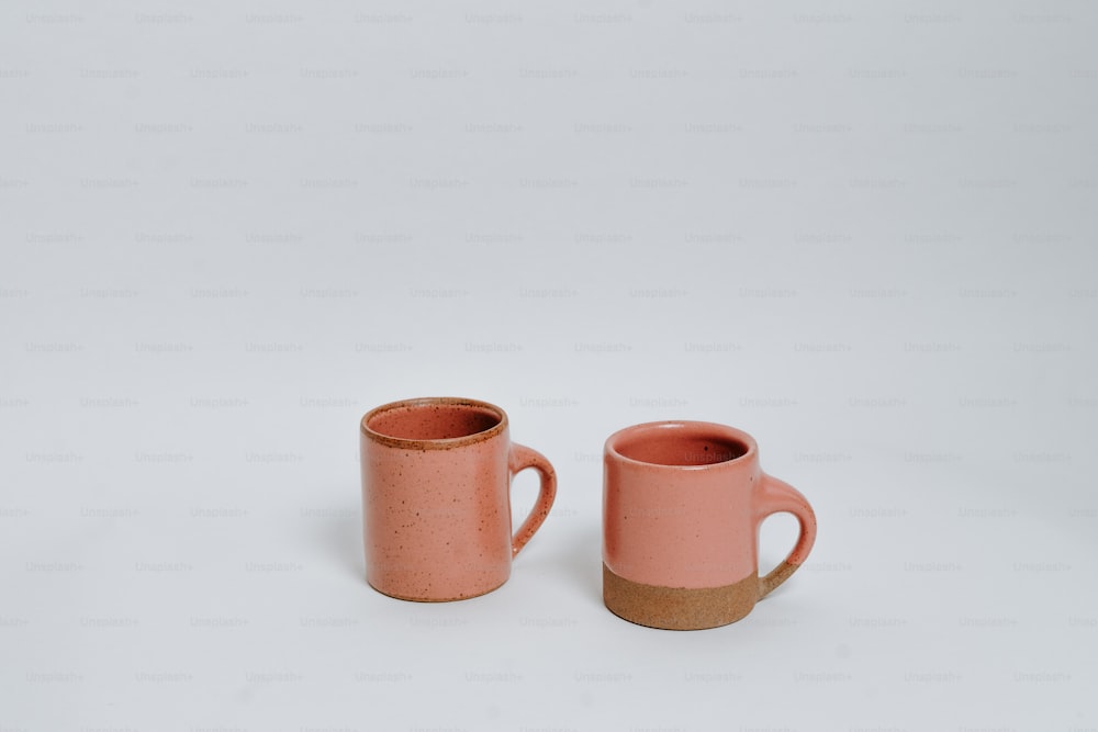 a couple of pink cups sitting next to each other