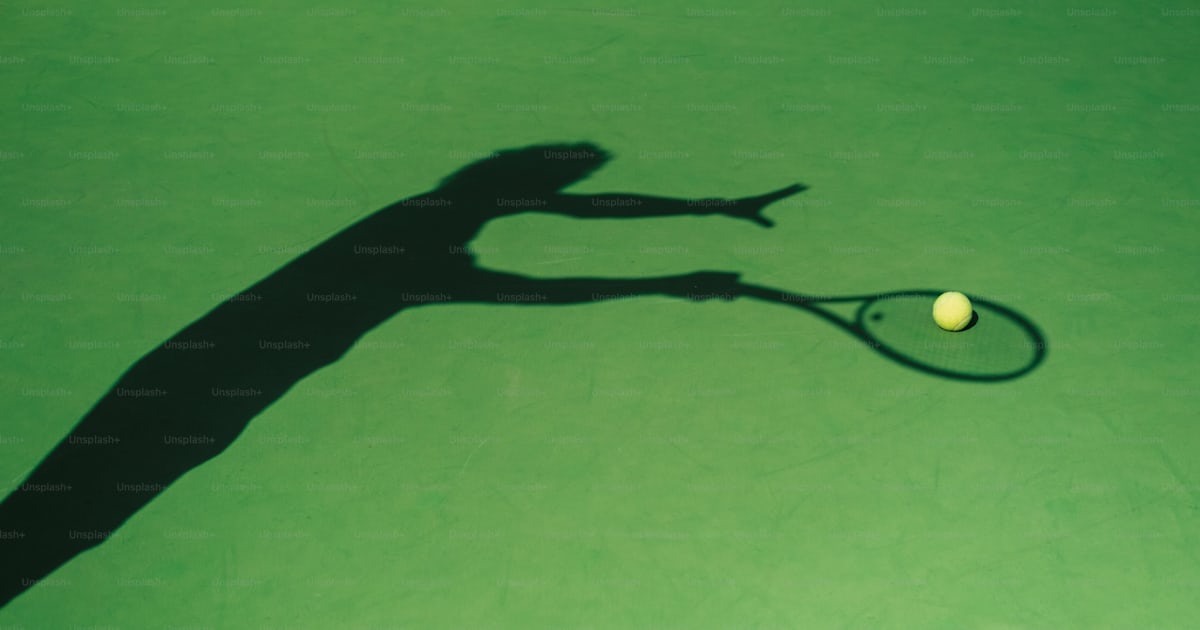 A shadow of a person holding a tennis racket photo – Sport Image on ...