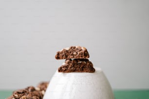 a stack of cookies sitting on top of a white egg