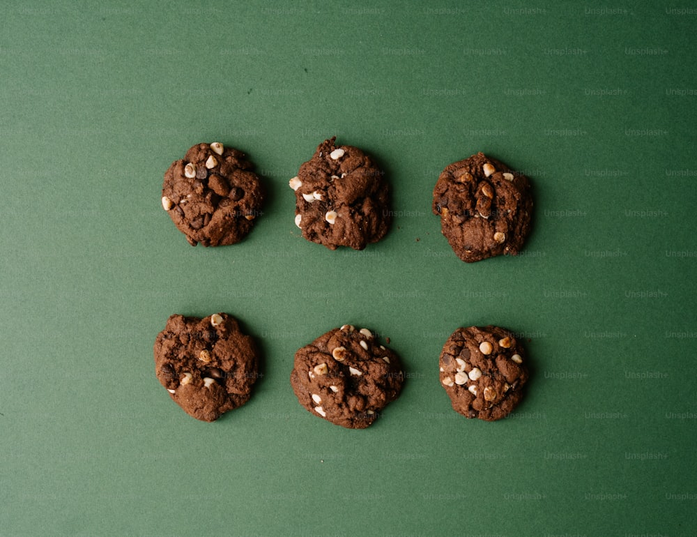 a group of cookies sitting on top of a green table