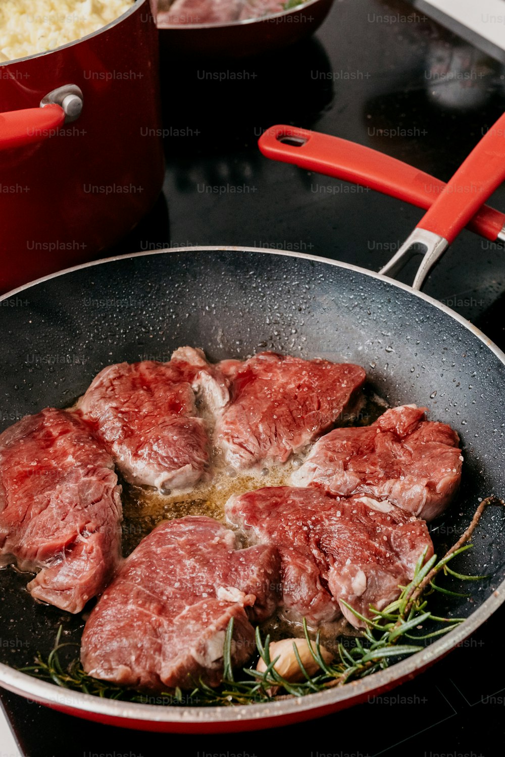 a pan filled with meat on top of a stove