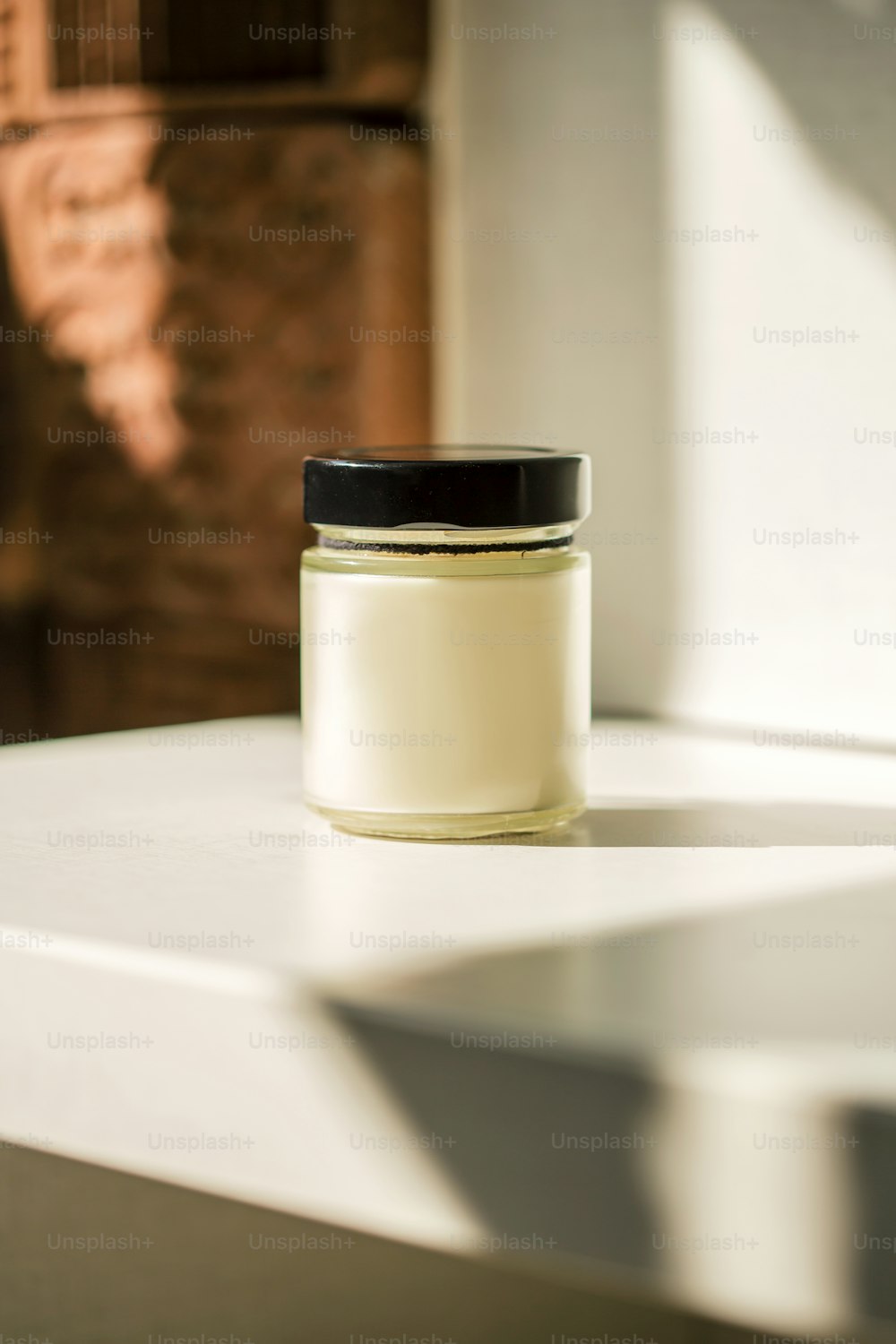 a jar of cream sitting on top of a table