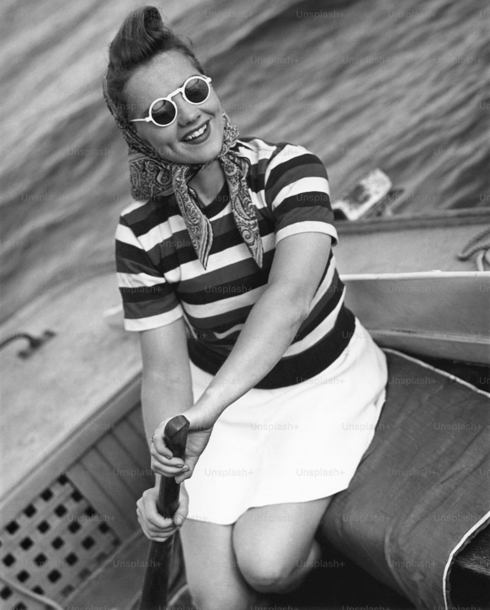 UNITED STATES - CIRCA 1950s:  Woman on small sail-boat.