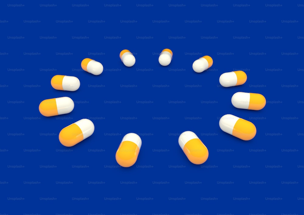 Un círculo de píldoras blancas y naranjas sobre un fondo azul
