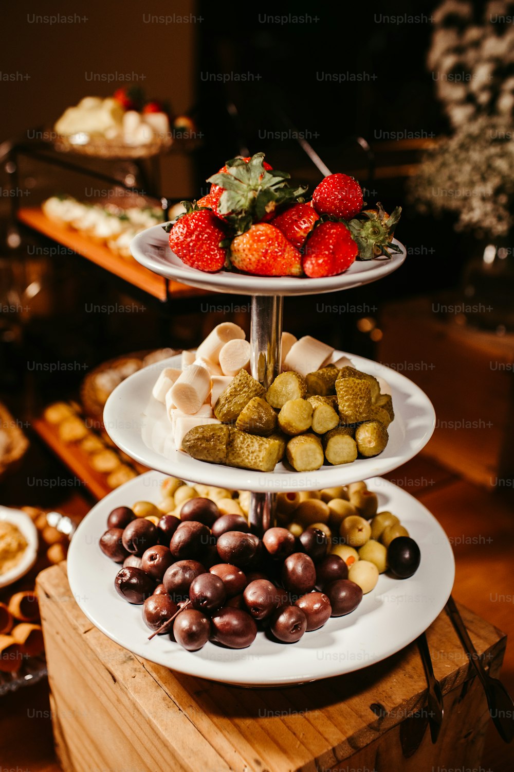 a three tiered tray of food on a table