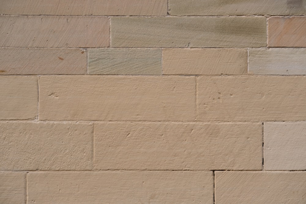 a close up of a brick wall with a clock on it