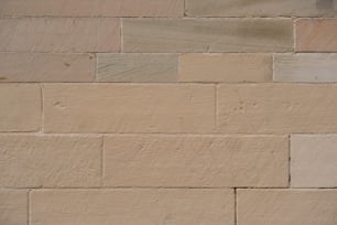 a close up of a brick wall with a clock on it