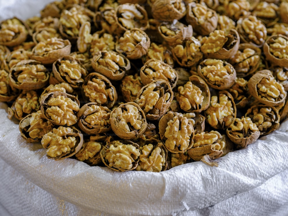 a white bowl filled with nuts on top of a table