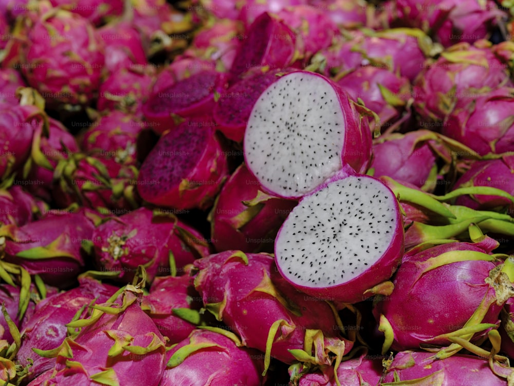 a pile of dragon fruit sitting on top of each other