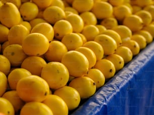 a bunch of lemons sitting on top of a blue table