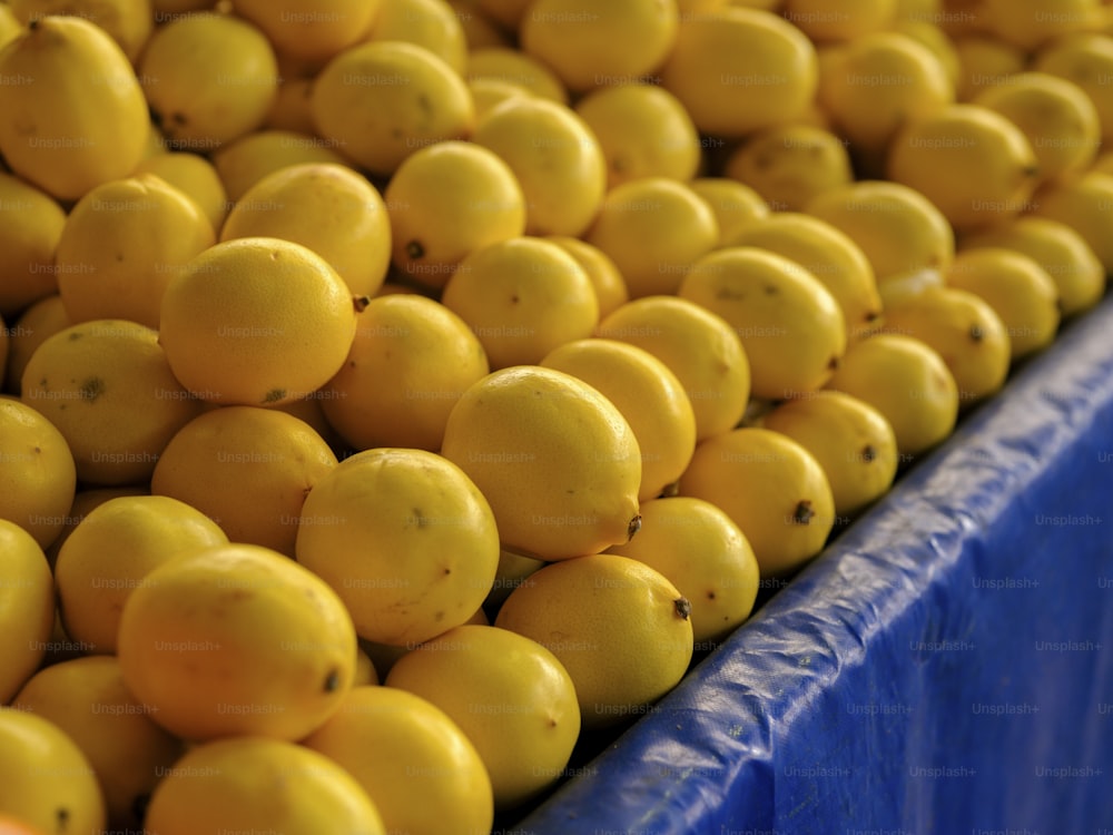 a bunch of lemons sitting on top of a blue table