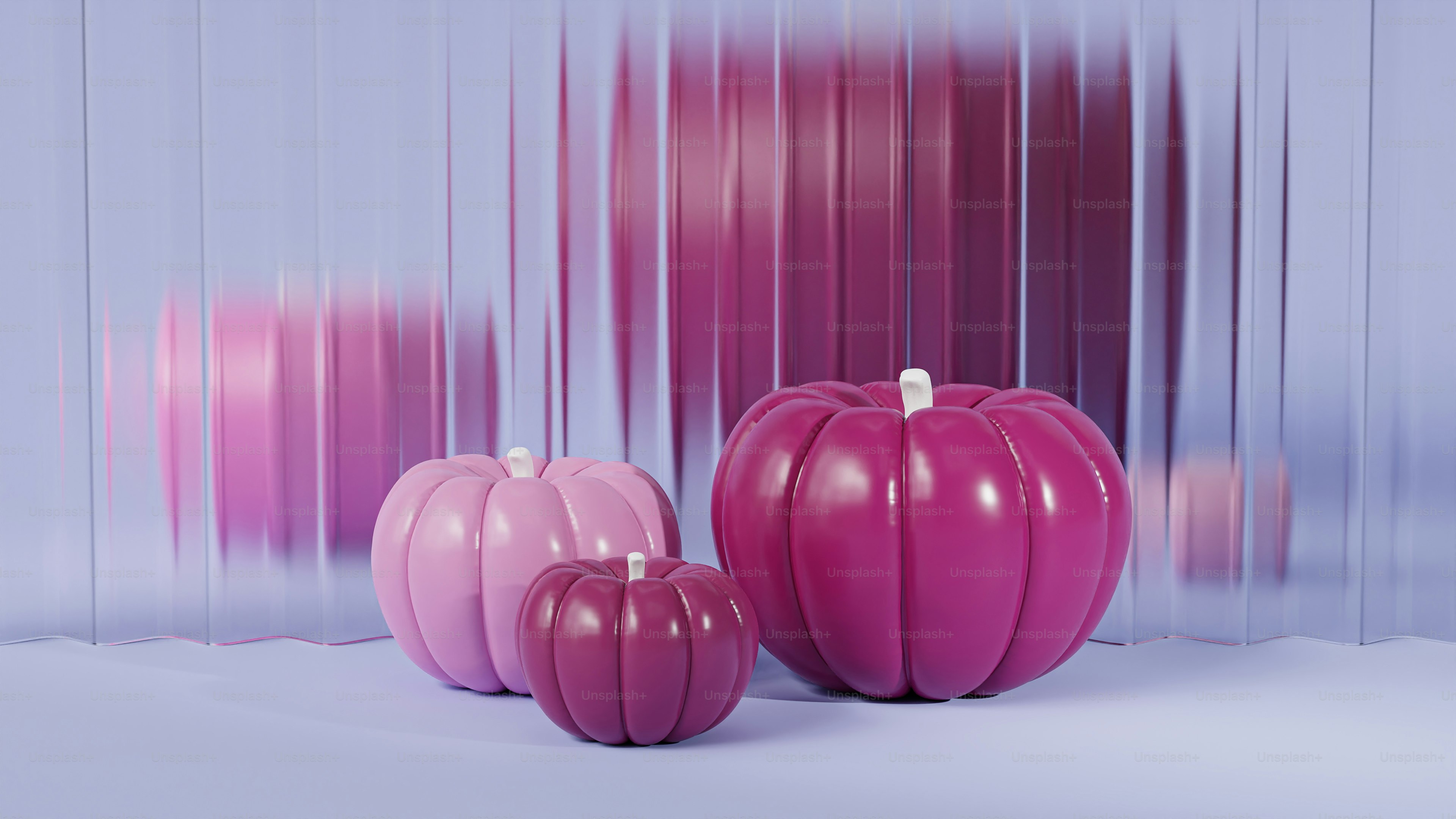 분홍색 호박 한 무리가 나란히 앉아 있다