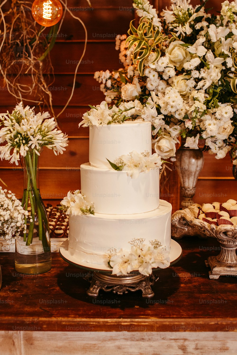 a table topped with a white three tier cake