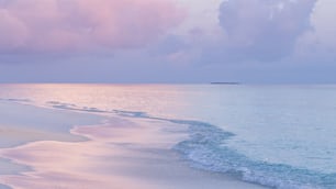 a view of a beach with waves coming in to shore