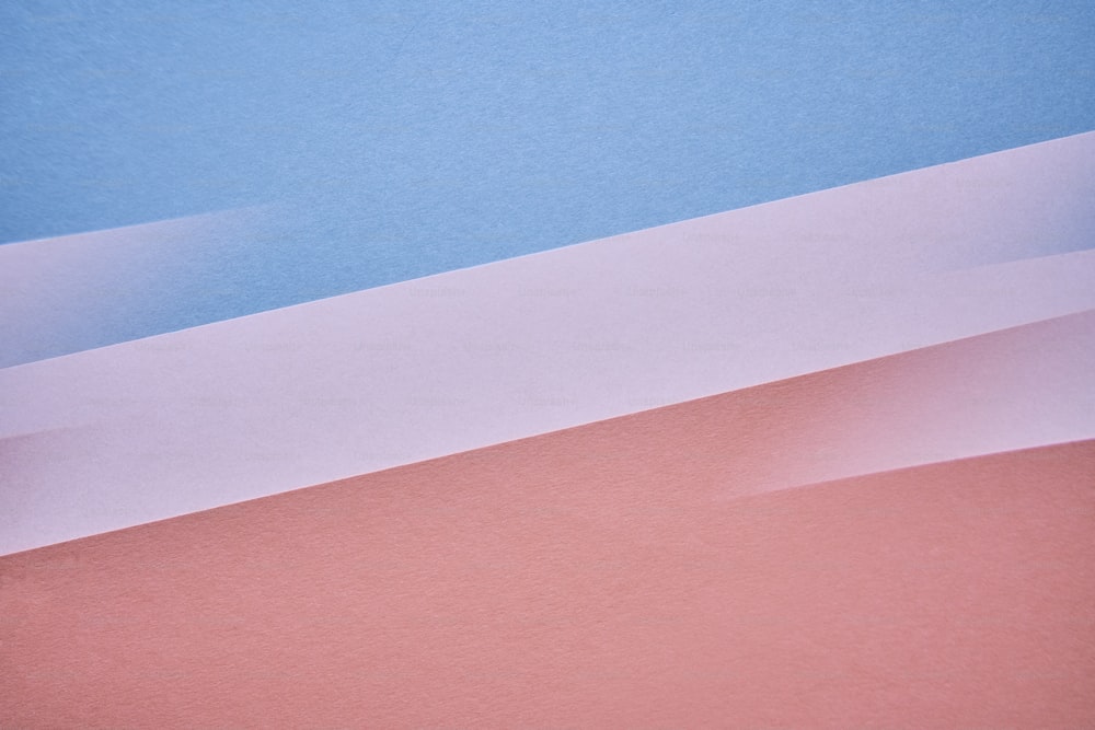 a cell phone sitting on top of a pink and blue surface