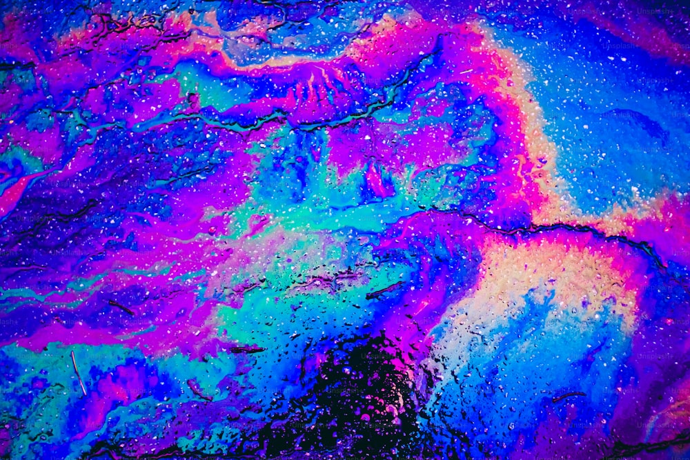 an abstract painting of blue, purple, and pink