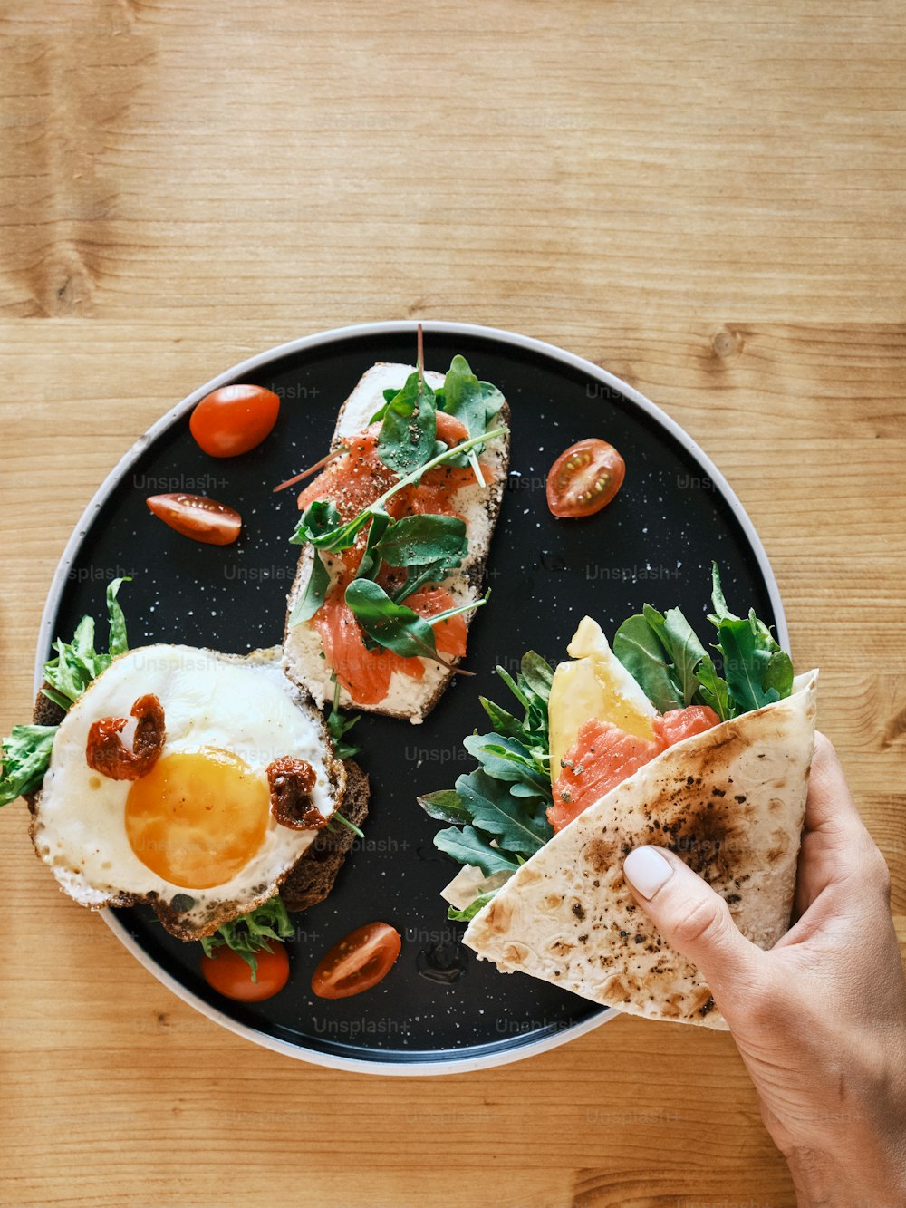 a person holding a plate with food on it