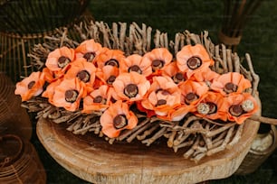 a bunch of orange flowers sitting on top of a wooden table